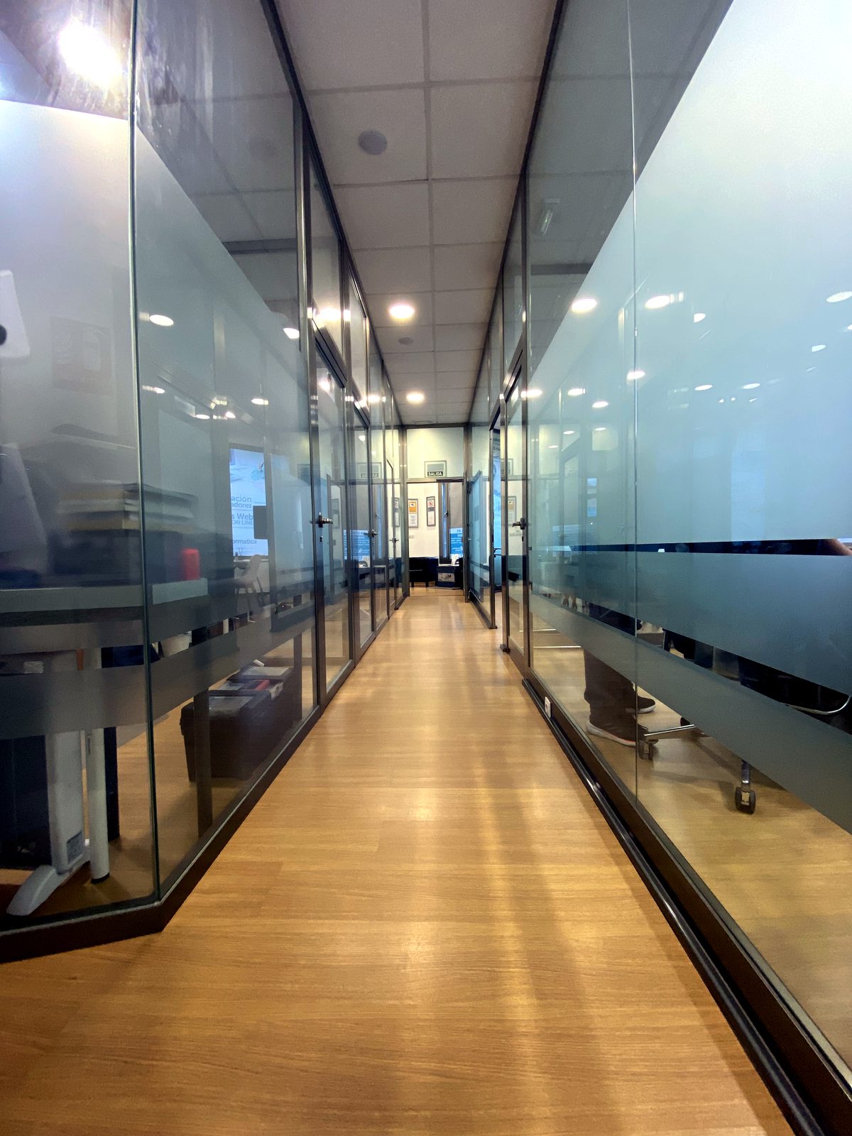 Corridor with glazed private offices at Coworking Oleiros